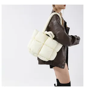Quilted puffer tote bag in cream white showing large grid stitching and padded texture