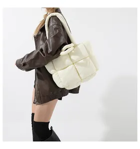 Detailed view of cream quilted puffer tote bag with soft down cotton texture