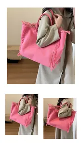 Pink canvas tote bag featuring decorative fringe edges and large capacity for daily commuting