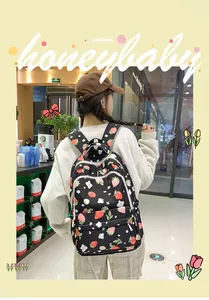 Detail of cute strawberry print backpack showing large capacity and durable zipper pockets