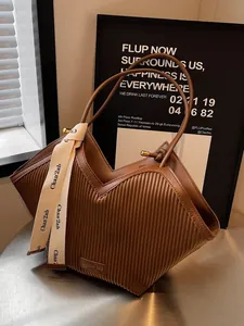 Brown pleated large capacity tote bag with V-shaped opening and silk scarf accessory