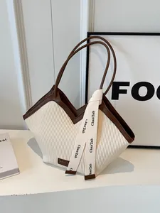 Off-white pleated tote bag with brown leather handles and ribbon for commute work