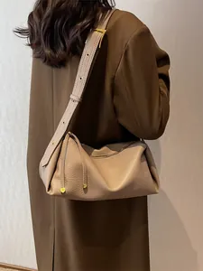 Minimalist light brown pebbled leather satchel with unique folded accordion structure