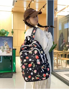 Detail of strawberry print backpack showing side view with multiple zipper pockets