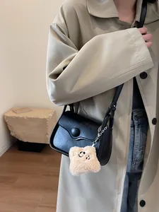 Retro black leather crossbody flap bag with plush star charm and round buckle detail