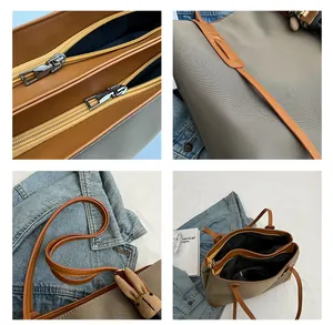 Detail view of large tote bag showing triple compartment layout and dual zipper closures