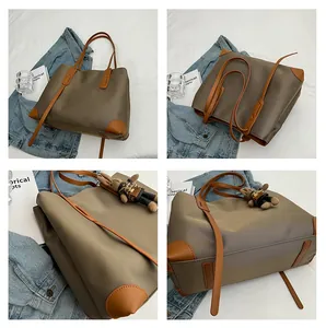 Detailed four-way view of olive tote bag with leather handles and a cute bear charm