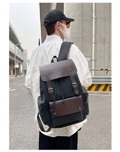 Vista detallada de mochila de lona vintage con correas de cuero usada por un modelo