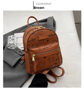 Detailansicht des braunen Rucksacks aus PU-Leder mit Litschi-Muster und Bärenmotiv