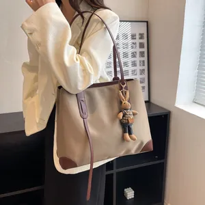 Minimalist large-capacity khaki tote bag with a brown leather strap and cute bunny pendant