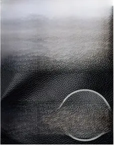 Detail of waterproof black oil wax leather texture with silver kangaroo brand logo