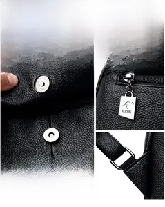 Detailed view of silver magnetic snap button and kangaroo logo metal zipper on black PVC bag