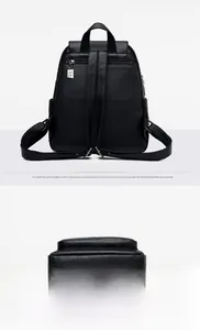 Detail view of the soft black leather backpack showing rear anti-theft pocket and bottom logo