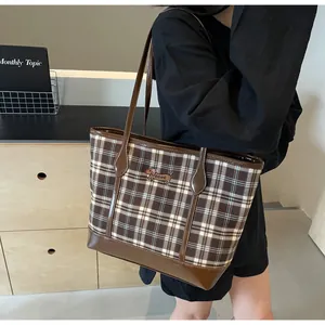 Detail of vintage brown plaid tote bag featuring a cute dachshund embroidery and faux leather