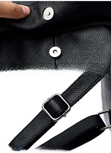 Detail of black lychee grain leather backpack with magnetic buckle and adjustable strap