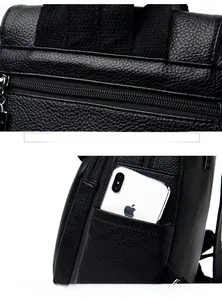 Detail of black pebbled leather backpack showing back zipper pocket and side phone pocket