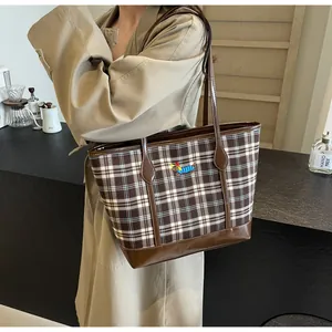 Detail of vintage brown checkered tote bag with a cute cartoon dachshund embroidery
