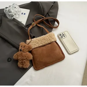Brown suede crossbody bag with fleece trim and cute plush bear charm detail