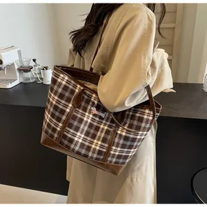 Close-up of vintage tote bag featuring brown plaid pattern and rainbow dachshund embroidery