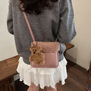 Pink faux suede crossbody bag with fleece trim and cute bear charm for women