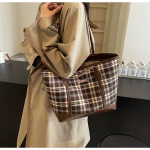 Detail of vintage brown plaid tote bag with dachshund embroidery and leather trim