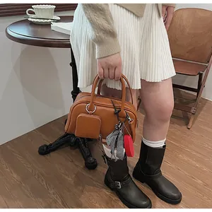 Brown leather Boston bag with retro charm featuring a unique checkered charm and mini pouch