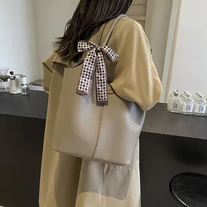 Litchi pattern leather bucket bag in khaki grey with a checkered silk scarf accessory