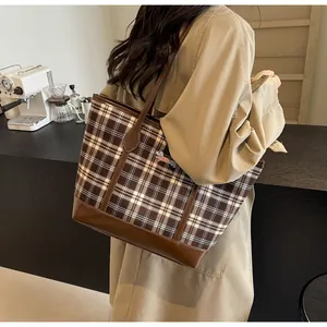 Detail of vintage plaid tote bag with leather trim and dachshund embroidery