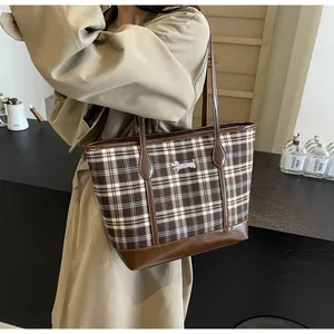 Detail of vintage plaid tote bag featuring a cute dachshund embroidery and leather base