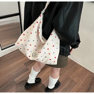 Minimalist white canvas crossbody bag with colorful polka dots and a large capacity design