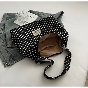 Close-up of a large leopard print canvas tote bag with zipper closure and inner pocket