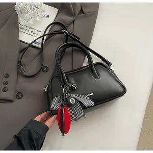 Close-up of black retro bowling bag with Far K logo, heart print and trendy charms
