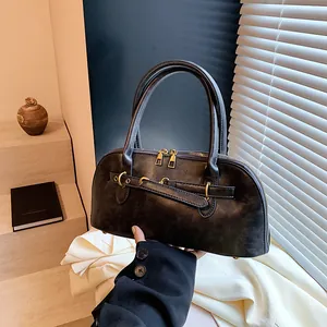 Vintage dark brown shell handbag with gold hardware and matte leather texture for women