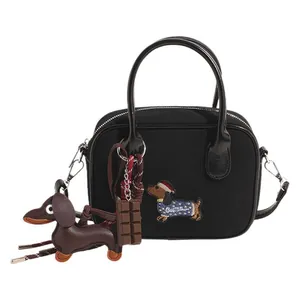 Fashionable black dachshund embroidery canvas handbag with leather handles and bag charms