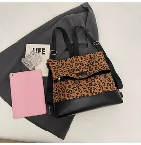 Detail of leopard print backpack with black leather base on a lifestyle background