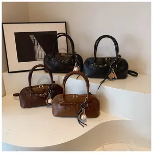 Close-up of vintage bowling bags in brown and black with leather texture and baseball charms