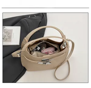 Capacity display of apricot leather bucket bag showing internal storage for phone and wallet