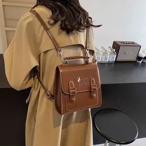 Vintage brown leather backpack with dachshund logo shown from a rear perspective