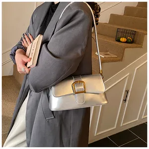 Close-up of a silver metallic baguette bag with a vintage square buckle detail