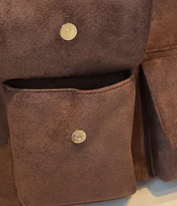 Close-up of magnetic silver buckles on premium dark brown suede tote bag details