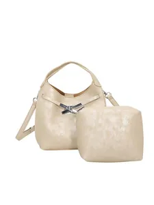 Champagne gold faux leather bucket bag with metallic lock and inner pouch on white background