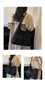 Macro detail of black cargo style tote bag featuring metal eyelet strap and large pockets