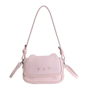 Cute pink cat-shaped crossbody bag with embroidered face and knot detail shoulder strap