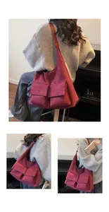 Macro view of burgundy tote bag showing textured material and double front flap pockets