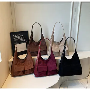 Close-up of retro suede tote bags with double front pockets in five various colors