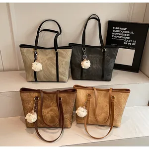 Minimalist tote bags in four colors arranged on stairs with decorative plush charms