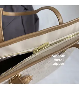 Detail of premium golden hardware zipper on a jacquard fabric tote bag