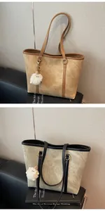 Detailed close-up of large minimalist tote bags with vintage texture and plush pendants