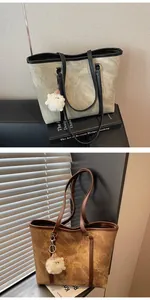 Detail of minimalist tote bag with smooth texture and cute sheep plush pendant