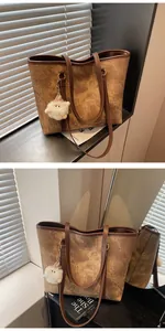 Detailed texture of brown retro tote bag with thin straps and plush monster charm